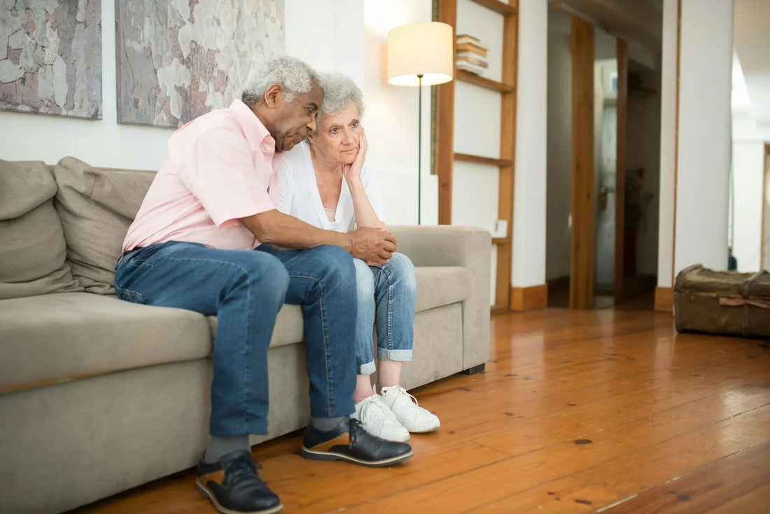 Older couple sitting together on a couch in a living room